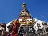 
The first sight on reaching the top of the stairs is the Swayambhunath stupa flanked by two snow lions, with a giant gilded vajra above a mandala worked in a drum-shaped base. The earliest record of this stupa's existence dates from a 5C stone inscription; however, scholars and archaeologists believe that there was probably a shrine here as far back as 2,000 years ago.
